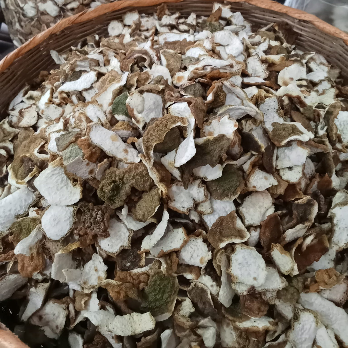 Close-up of dried herbs in a wooden bowl with a blurred background