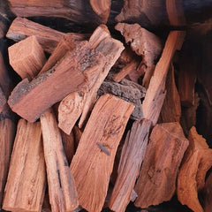 Close-up of wooden logs with a brand name in the corner