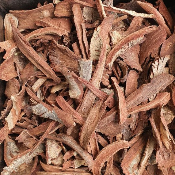Close-up of dried roots or herbs with a dark background