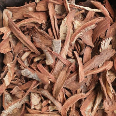 Close-up of dried roots or herbs with a dark background