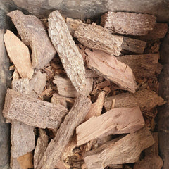 Stack of dried wood pieces in a stone container