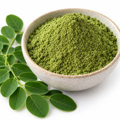 Close-up of Moringa oleifera leaf powder and leaves