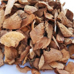 Pile of dried brown root pieces on a white background