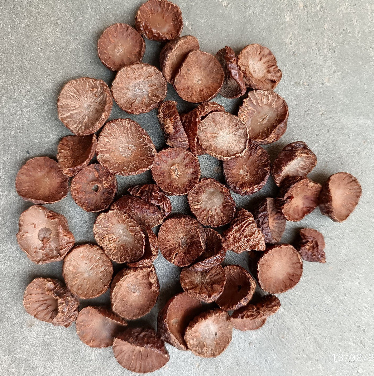 Brown nuts scattered on a gray surface